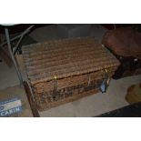 A large vintage wicker steam laundry basket