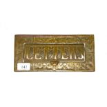A brass door letter box stamped "Letters"