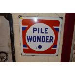 An enamelled sign for "Pile Wonder", 16.5ins x 17i