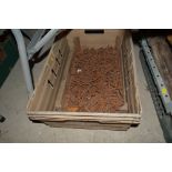 A box containing various red brick gutter nails