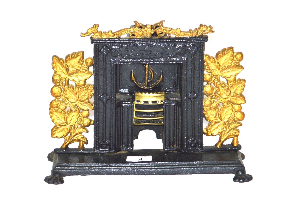 An Antique cast iron and brass miniature fireplace