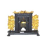 An Antique cast iron and brass miniature fireplace