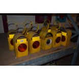 Nine yellow roadside warning lamps