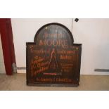 A painted wooden sign "Joseph Moore Instrument Mak