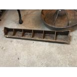 A small six section cast iron feed trough