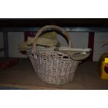 A vintage wicker basket, a folding camp bed and a