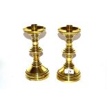 A pair of brass ecclesiastical candlesticks