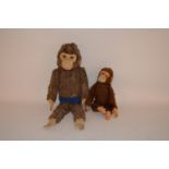 A large vintage monkey and one other straw-filled