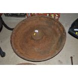 A circular cast iron feed trough