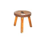 A small three legged wooden stool