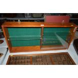 A teak hanging wall display cabinet with glass she