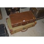 A canvas and leather mounted suitcase and a smalle