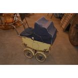 A vintage doll's pram, circa 1950's