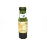 A vintage green glass furniture oil bottle, sold b
