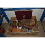 A box containing a collection of vintage games, an