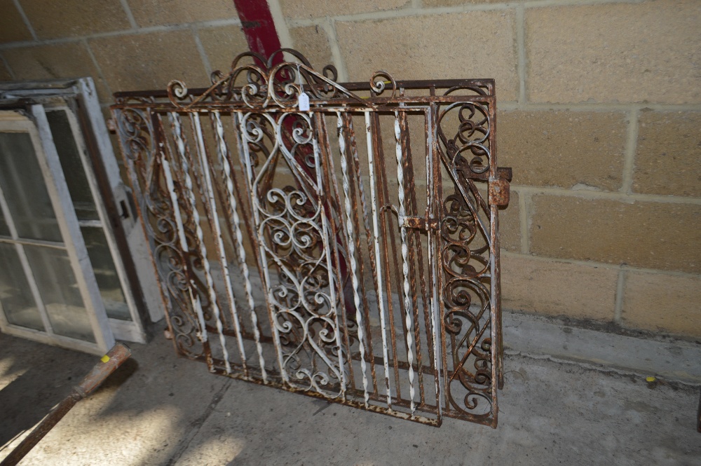 A pair of wrought iron gates and a similar side ga