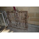 A pair of wrought iron gates and a similar side ga