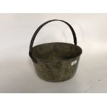 A brass preserve pan with iron swing handle