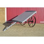 A builder's hand cart on metal wheels