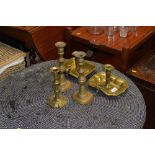 Three brass candlesticks; and two brass chamber st