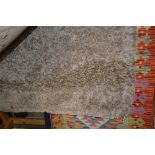 An approx 5'1" x 2'9" modern rug