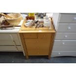 A light oak chest fitted two short over three long