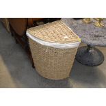 A wicker corner linen basket