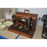 A Singer hand sewing machine in fitted case