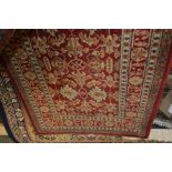 An approx 8'11" x 2'3" red patterned rug
