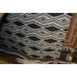 An approx 5'7" x 3'11" black and white patterned r