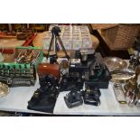 A collection of various binoculars; cameras; tripo