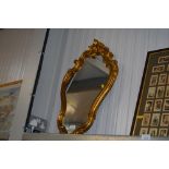 A gilt framed decorative wall mirror