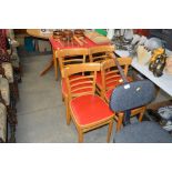 A draw leaf Formica topped kitchen table and four