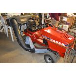 A Honda HT3810 ride on lawn mower with grass colle