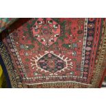 An approx 6'3" x 2'1" red patterned rug