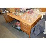 A modern light oak desk fitted five drawers