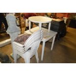 A white plastic garden table; four chairs and a lo