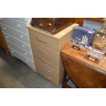 A beech effect chest fitted five drawers
