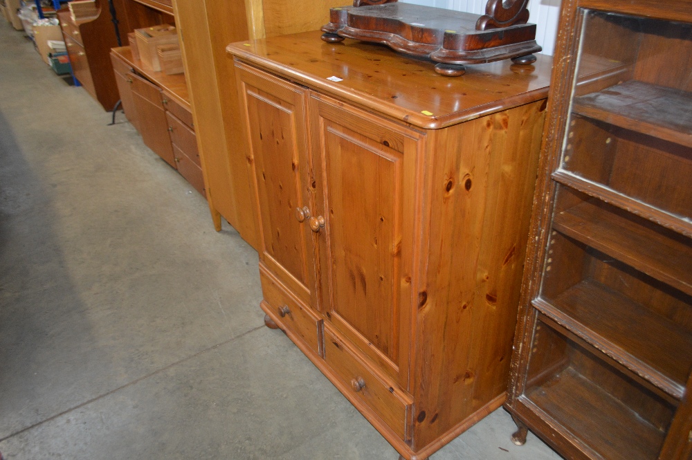 A pine TV cabinet fitted two drawers below