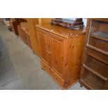 A pine TV cabinet fitted two drawers below