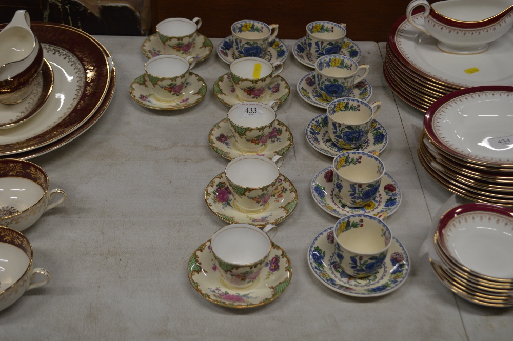 A set of six Aynsley decorated coffee cups and sau