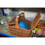 A wicker picnic hamper and contents