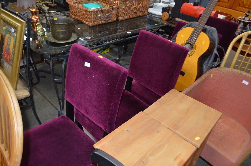 A set of four purple upholstered dining chairs