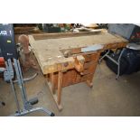 A wooden work bench fitted four drawers and a vice