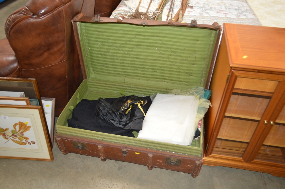 A wooden bound trunk and contents