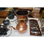 A brass and copper coal bin raised on paw feet tog