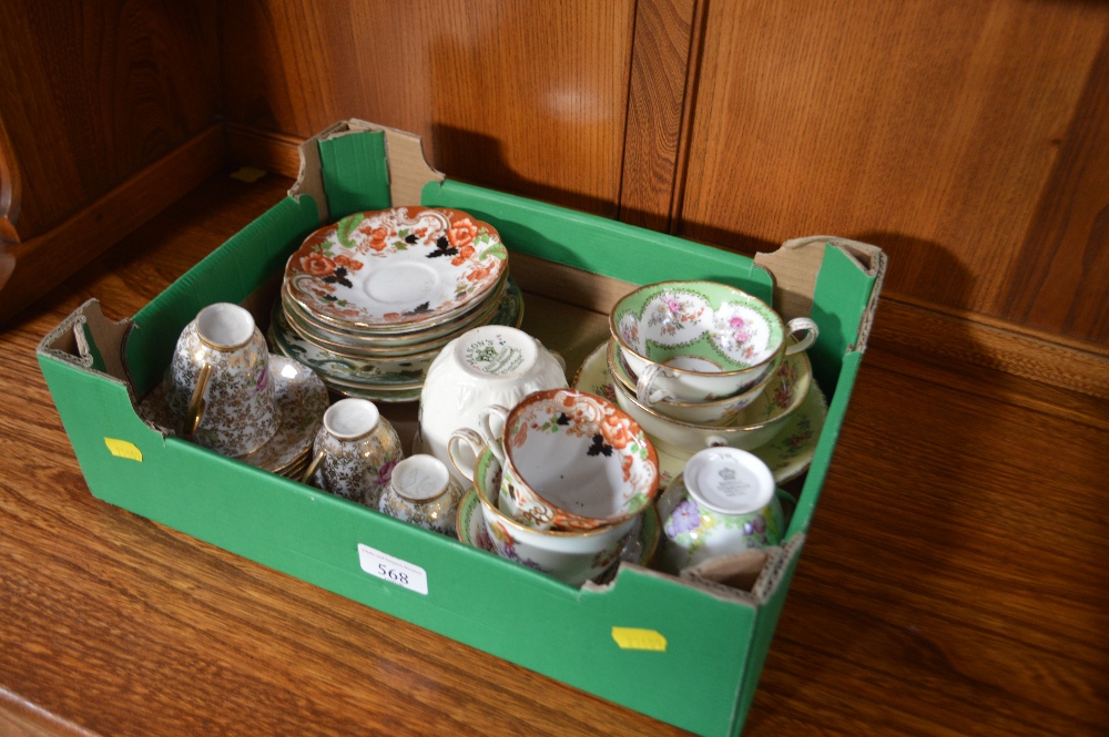 A box containing various floral decorated teaware