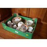 A box containing various floral decorated teaware