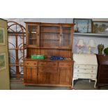 An Ercol style dresser raised on cupboard base fit