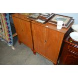 A pair of teak effect cupboards